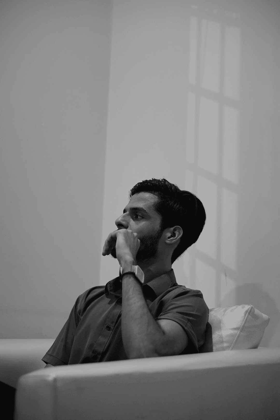 Mohsin, hand to chin, thinking